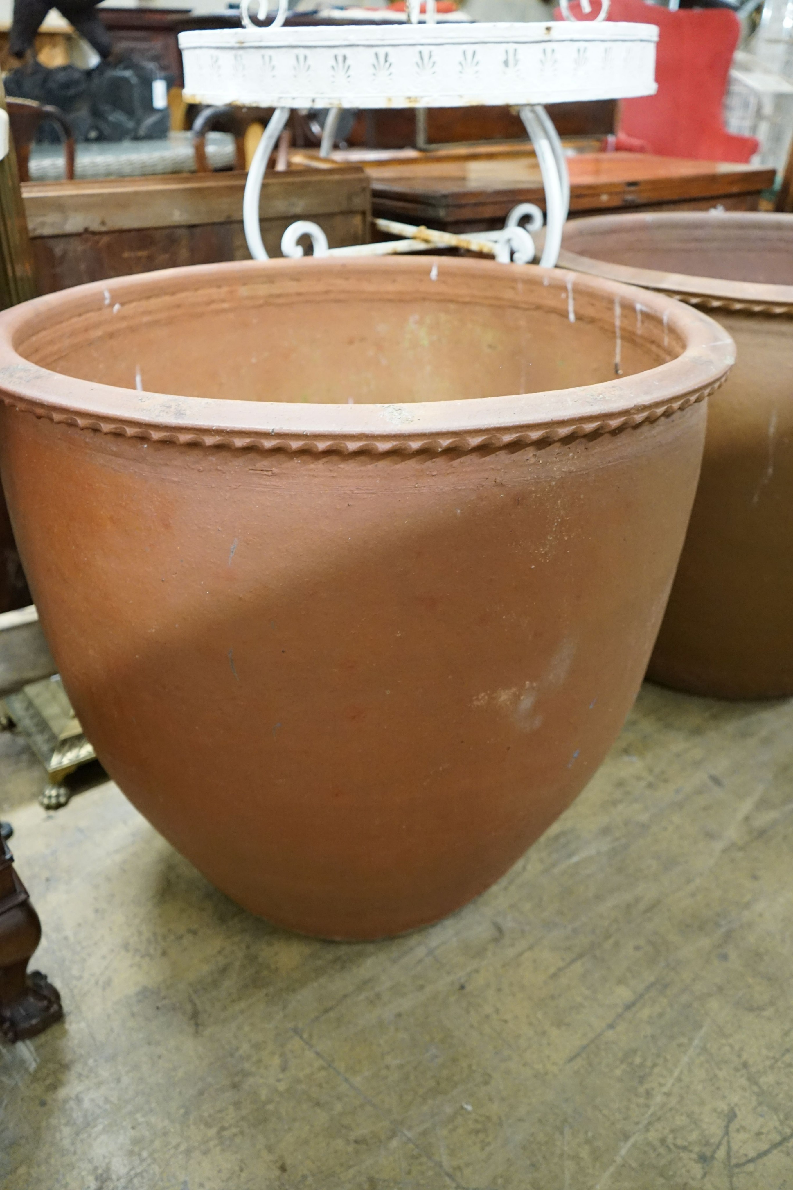 A pair of large circular terracotta planters, diameter 79cm, height 69cm